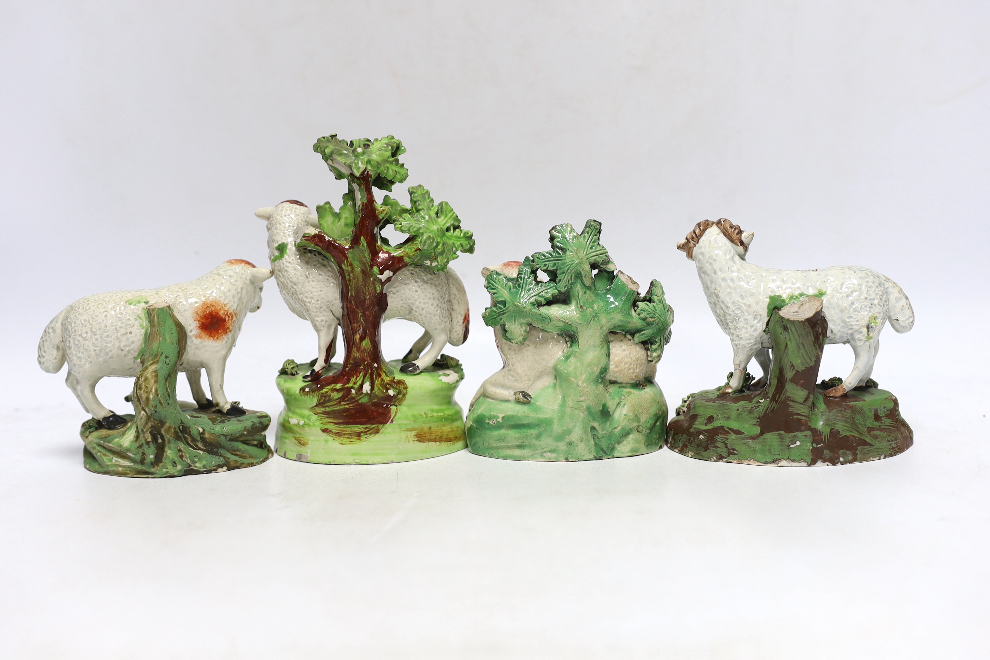 Four Staffordshire pearlware figures of sheep, c.1820-30, one with rare initials ‘PW’ to its back, largest 15cm high